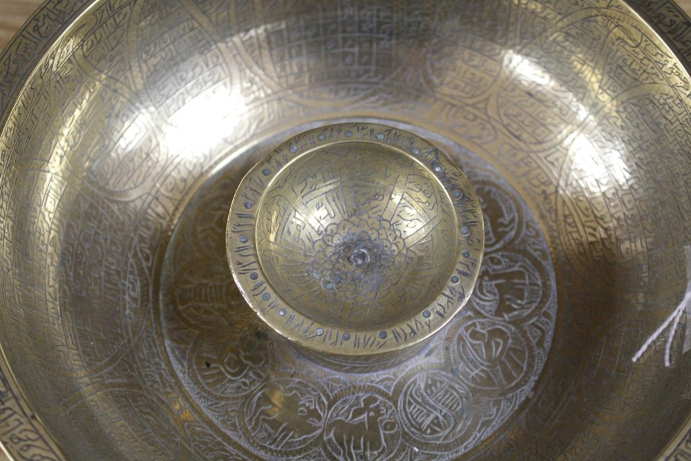 A large brass Persian magic bowl, Qajar dynasty, with inscribed decoration, diameter 21cm